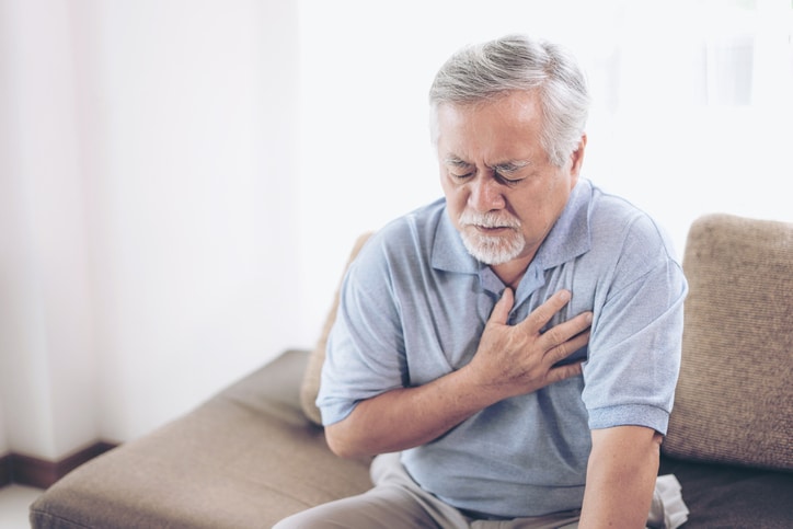 Senior male asian suffering from bad pain in his chest heart attack at home senior heart disease