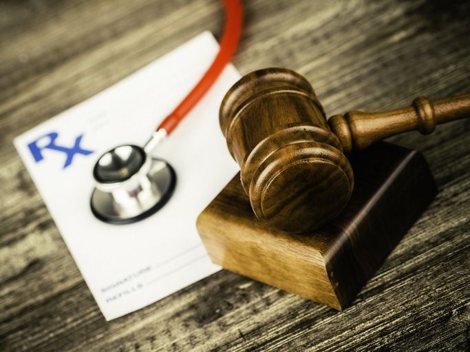 Prescription form with stethoscope and gavel. Medical Malpractice.