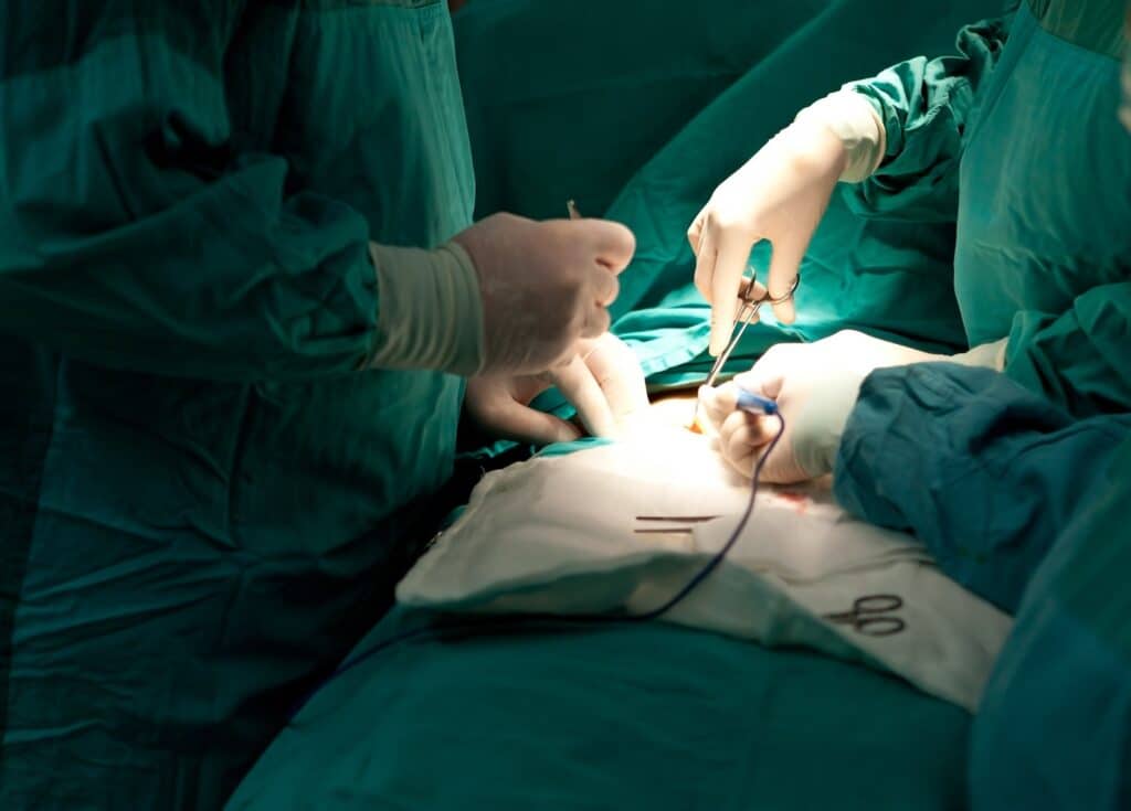 Several doctors performing ear surgery